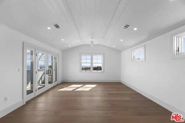 an empty room with windows and entrance