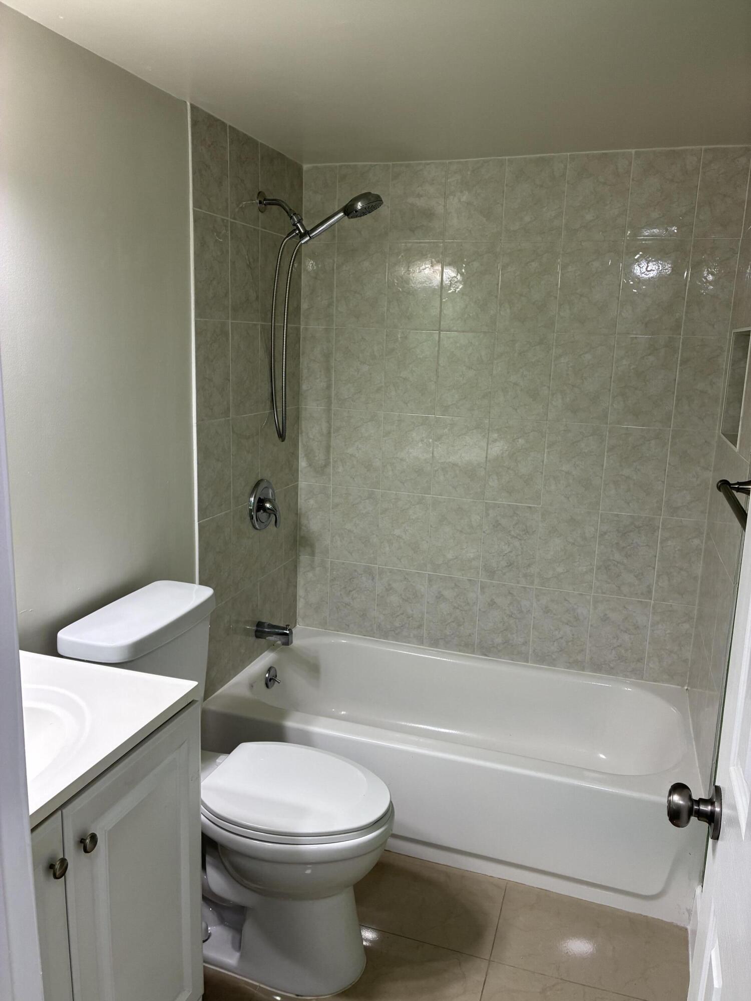 2955 Riverside Drive, Unit 103 Coral Springs, FL 33065 - Photo 11 of 26 a bathroom with a toilet a sink and bathtub