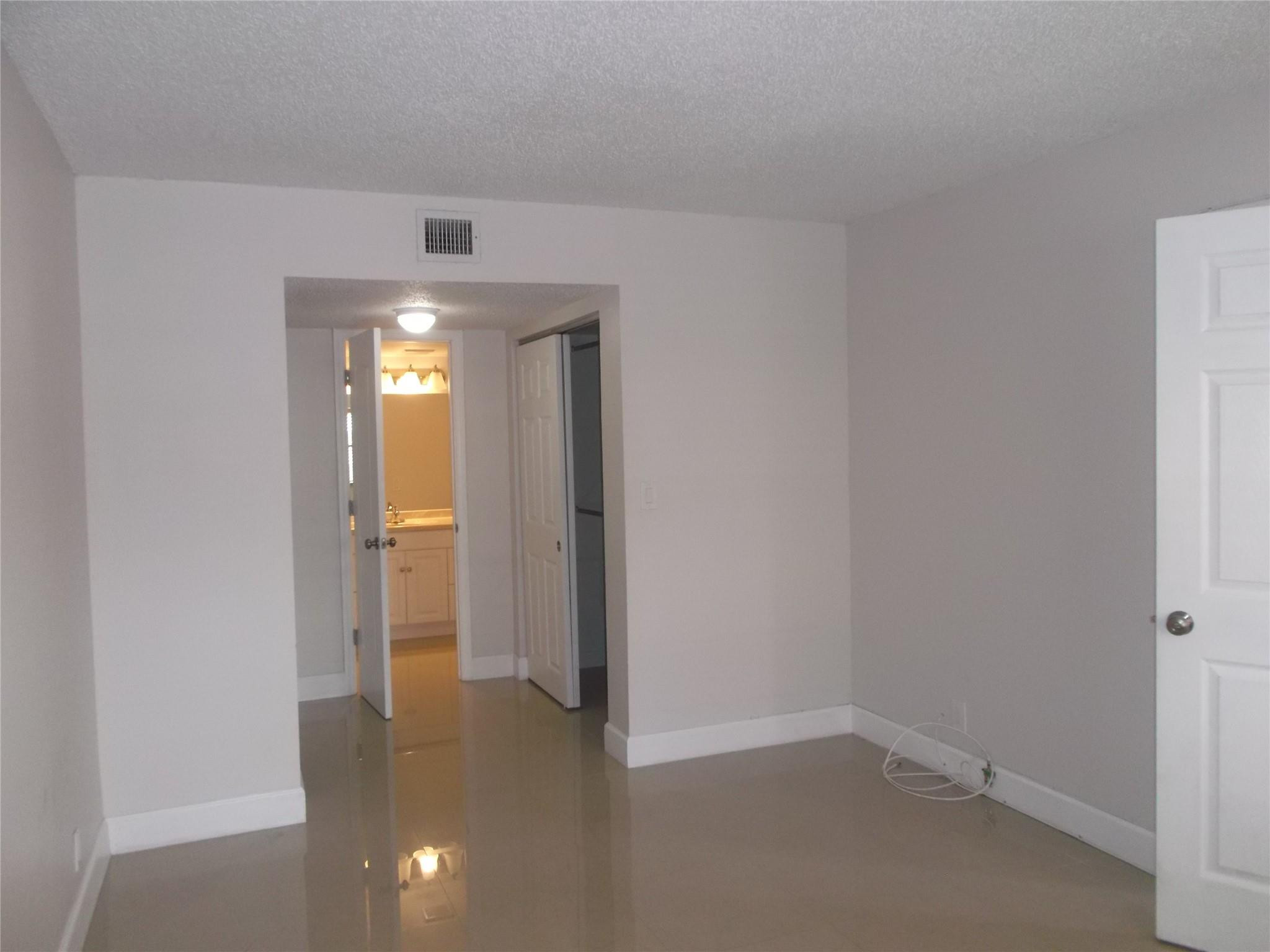2955 Riverside Drive, Unit 103 Coral Springs, FL 33065 - Photo 12 of 26 a view of a hallway with wooden shelves