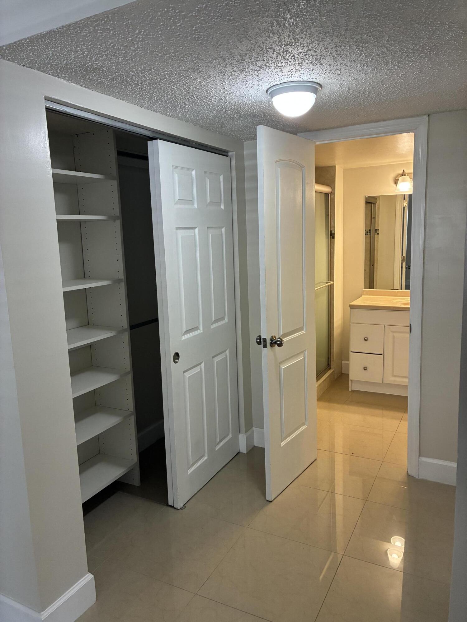 2955 Riverside Drive, Unit 103 Coral Springs, FL 33065 - Photo 14 of 26 a view of an empty room with cabinet and a window