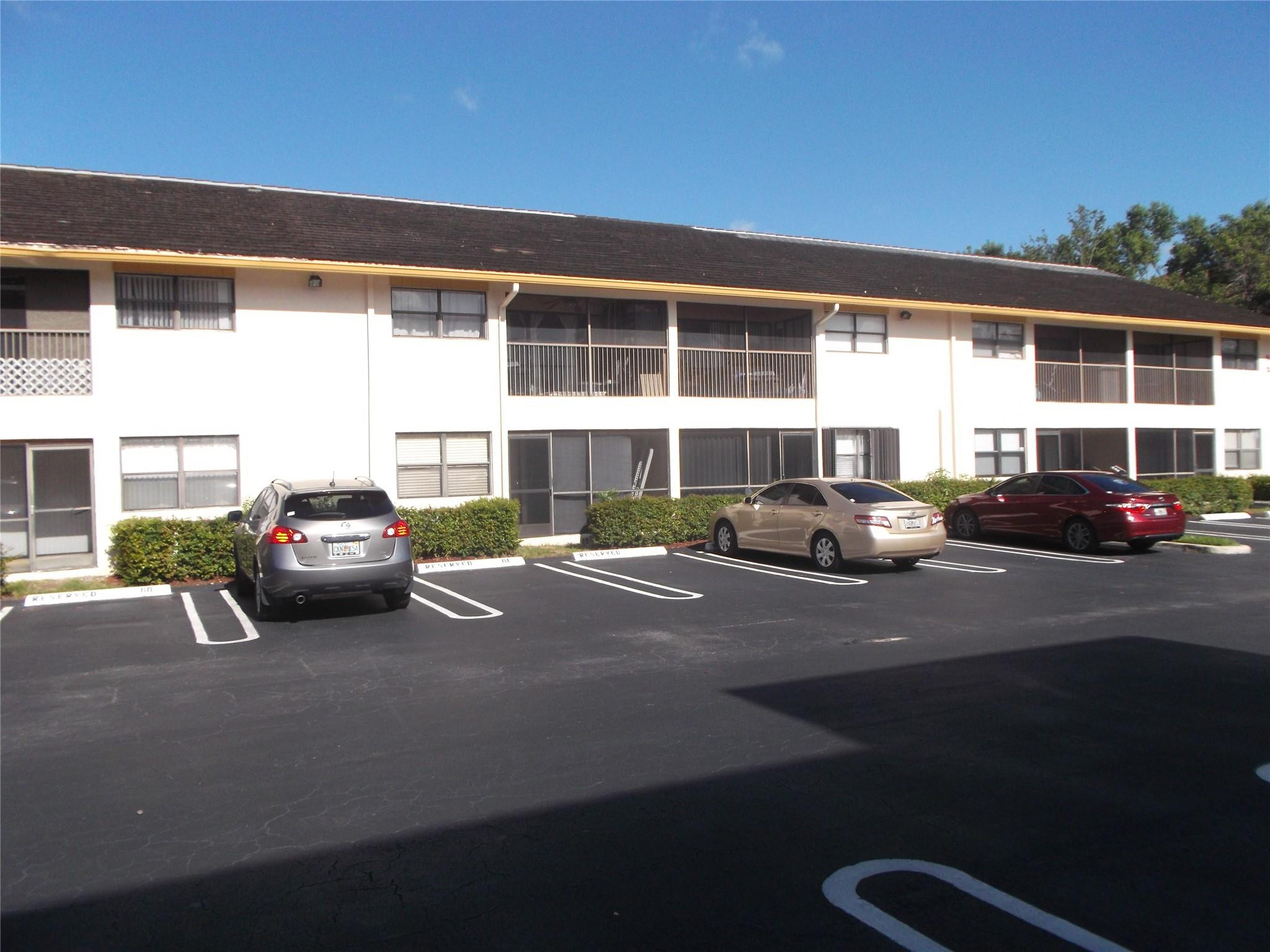 2955 Riverside Drive, Unit 103 Coral Springs, FL 33065 - Photo 22 of 26 a car parked in front of a building