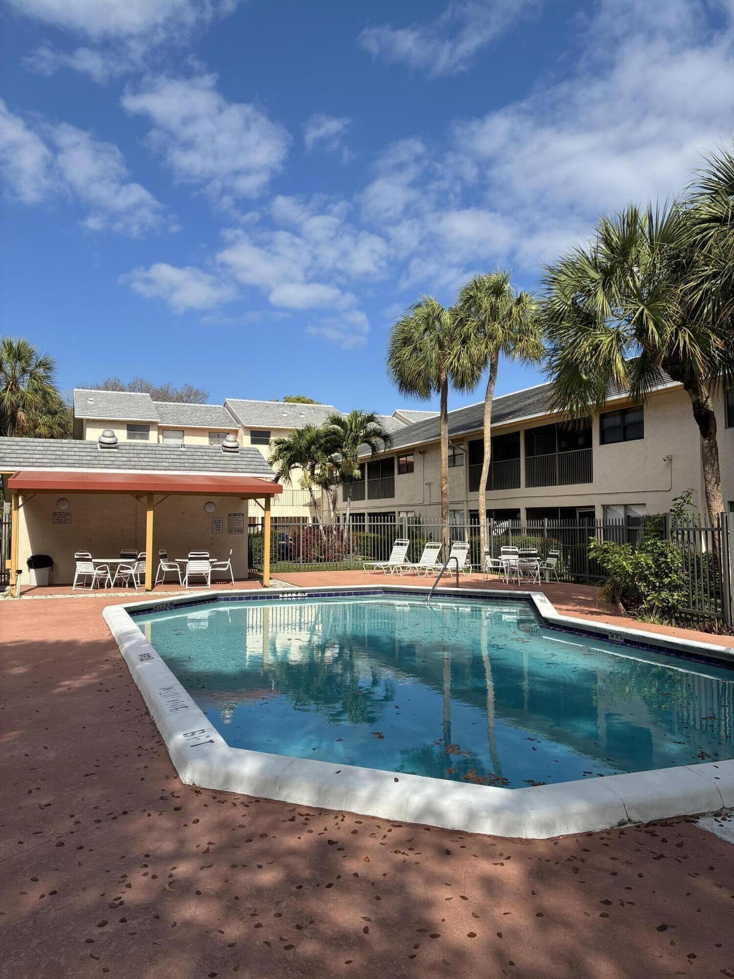 2955 Riverside Drive, Unit 103 Coral Springs, FL 33065 - Photo 26 of 26 front view of a house with a yard