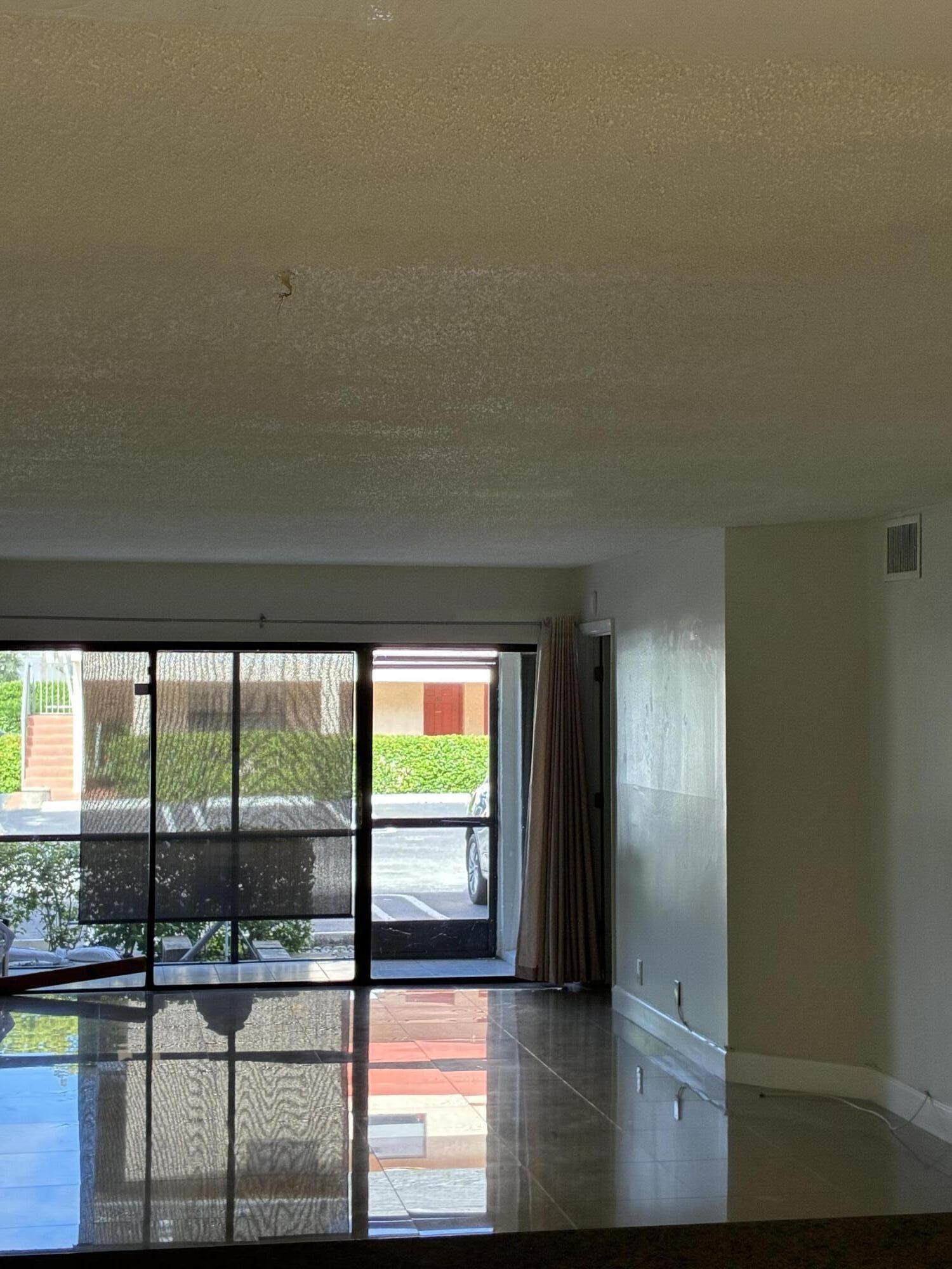 2955 Riverside Drive, Unit 103 Coral Springs, FL 33065 - Photo 5 of 26 a view of empty room with wooden floor and fan