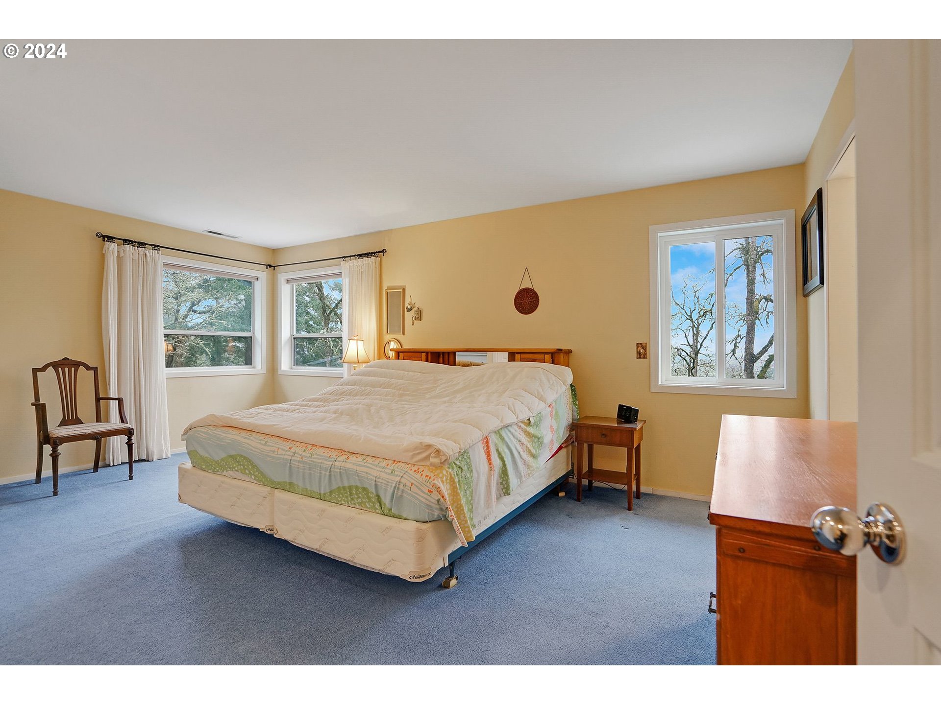 2080 Cherry Knoll Road Dallas, OR 97338 - Photo 19 of 48 a bedroom with a bed painting on wall and a large window