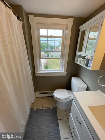 a bathroom with a toilet sink and a shower