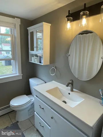 a bathroom with a sink mirror and toilet