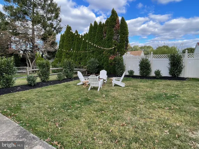 a view of a bench in backyard of house