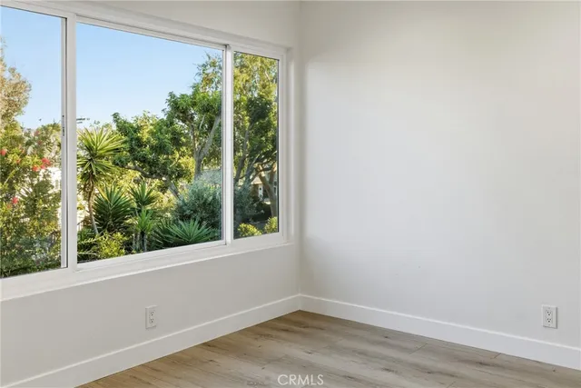 a view of room with window and wooden floor