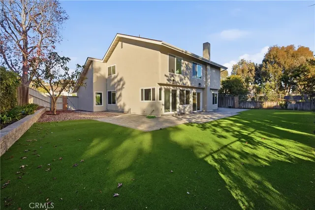 a front view of a house with a yard table and chairs