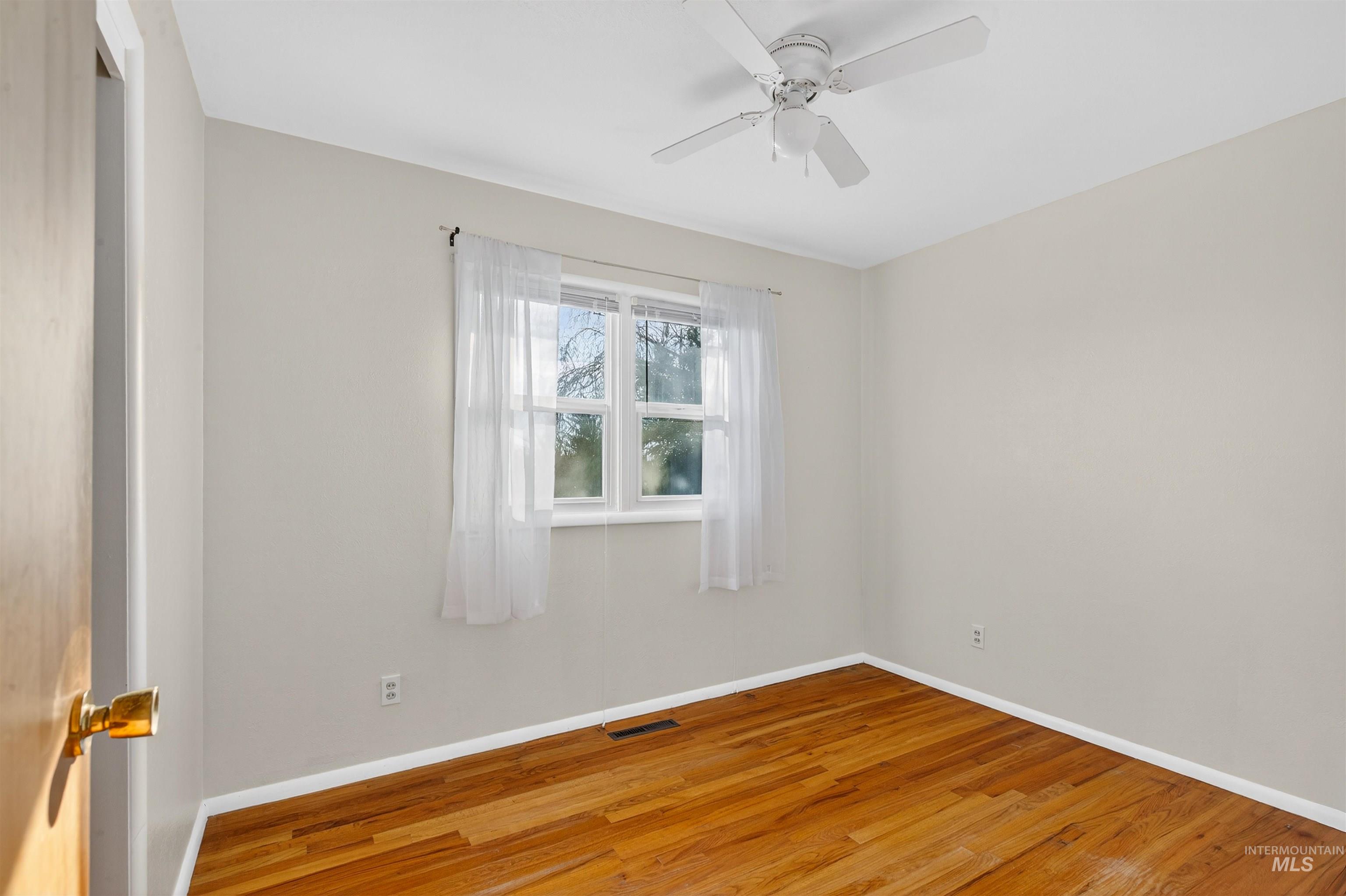609 Grelle Avenue Lewiston, ID 83501 - Photo 19 of 48 Empty room featuring hardwood / wood-style flooring and ceiling fan