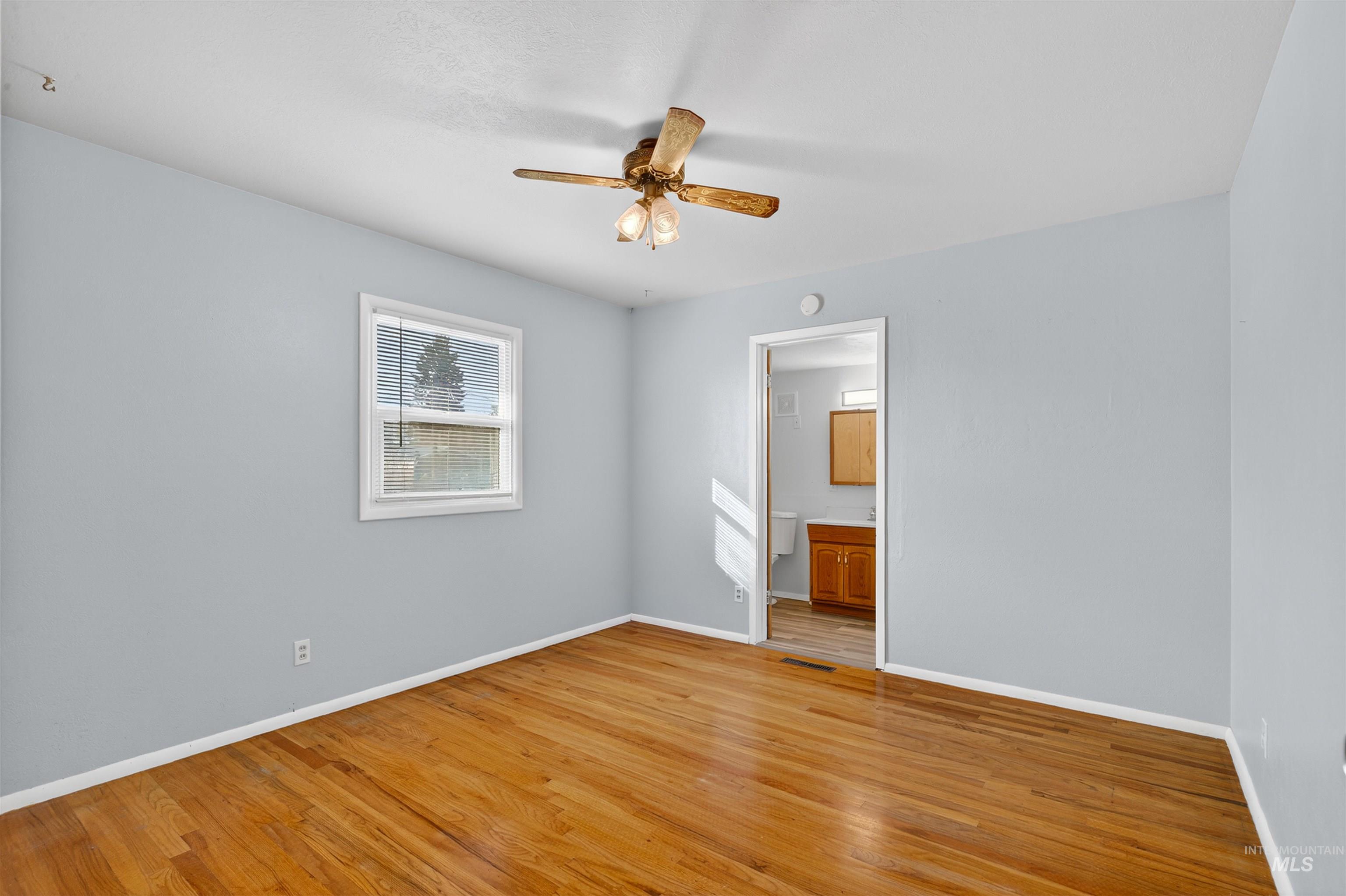 609 Grelle Avenue Lewiston, ID 83501 - Photo 23 of 48 Unfurnished bedroom with light wood-style flooring, ceiling fan, and ensuite bathroom