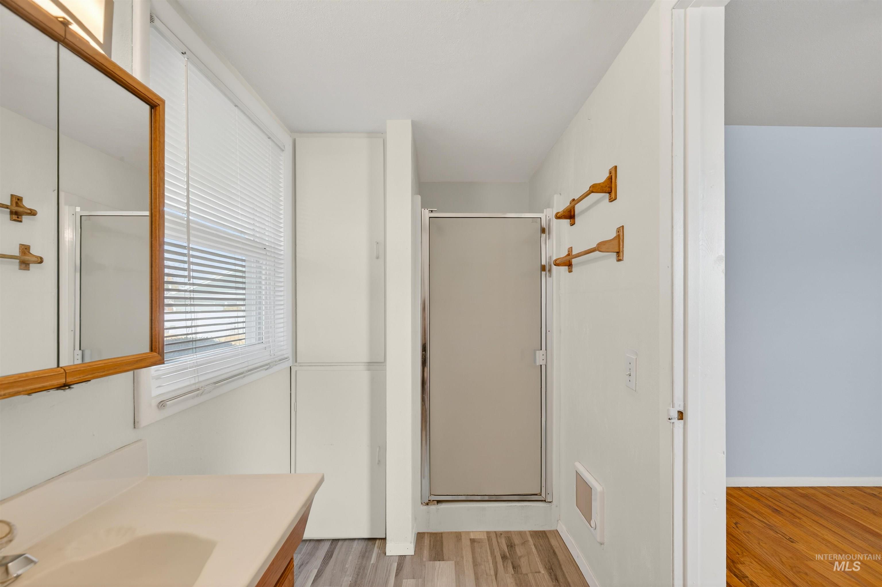 609 Grelle Avenue Lewiston, ID 83501 - Photo 25 of 48 Bathroom with light wood-style flooring, vanity, and a shower stall