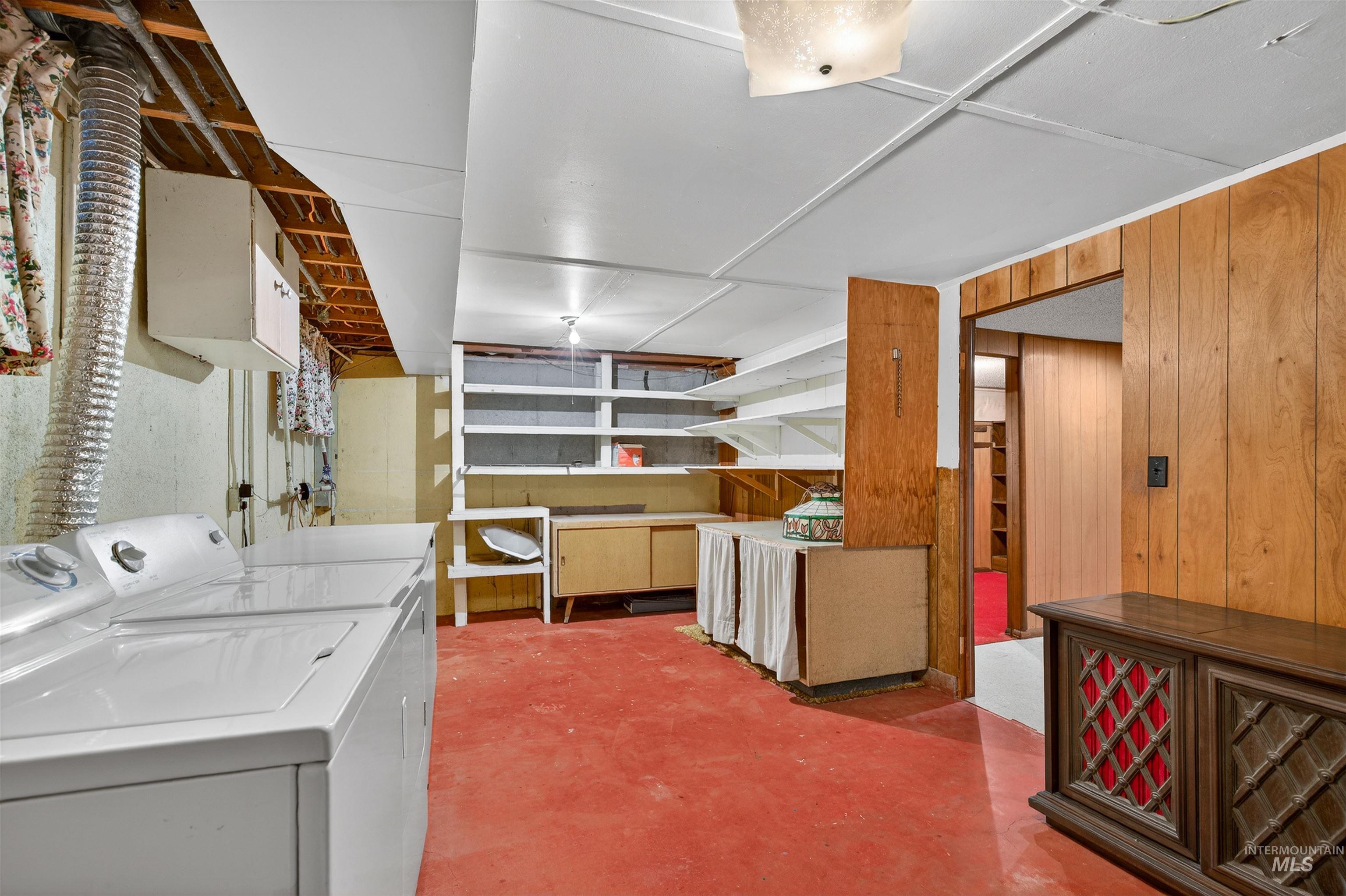 609 Grelle Avenue Lewiston, ID 83501 - Photo 32 of 48 Laundry area with concrete floors, washing machine and clothes dryer, and wood walls