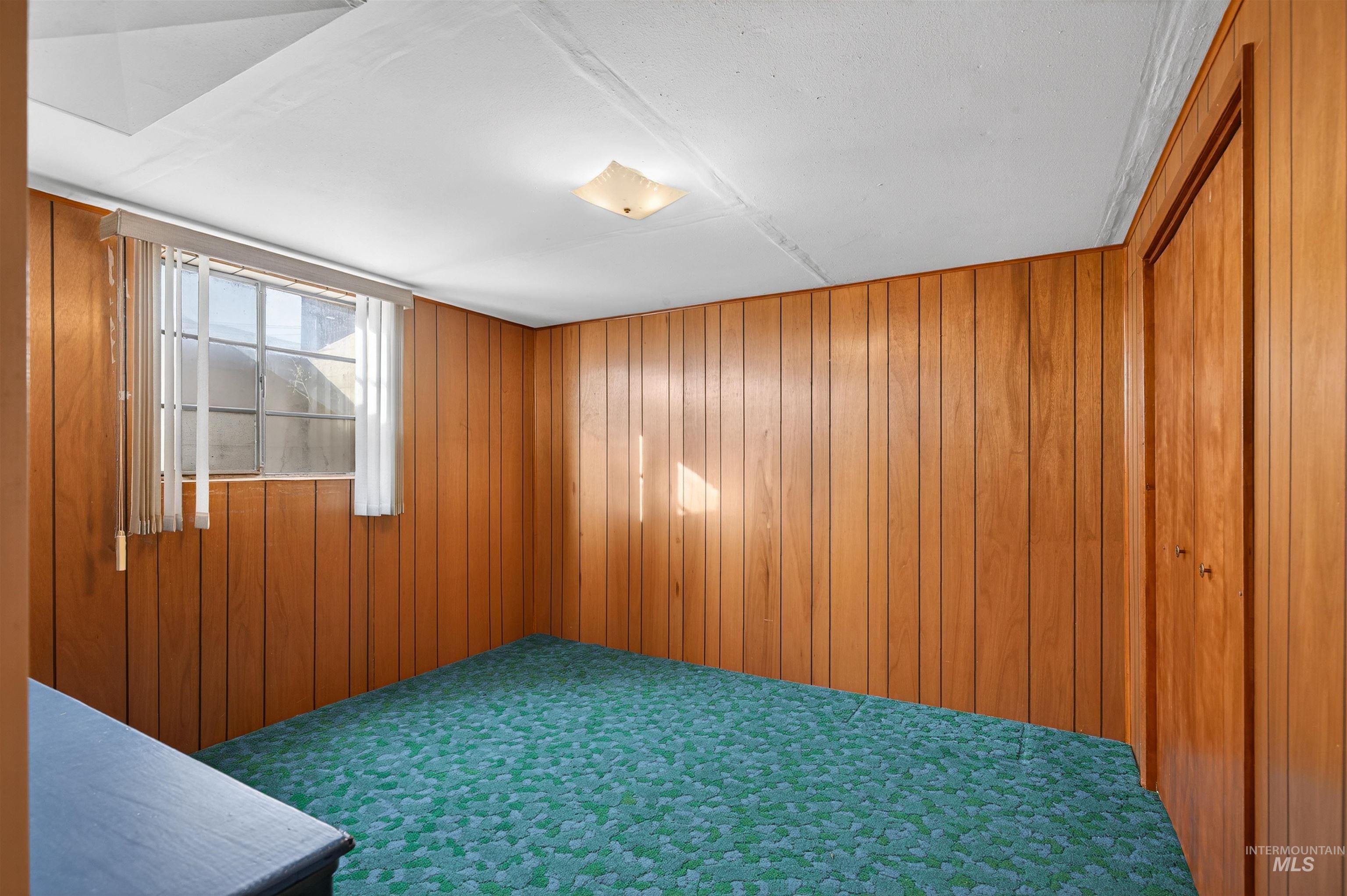 609 Grelle Avenue Lewiston, ID 83501 - Photo 34 of 48 Carpeted empty room featuring wooden walls
