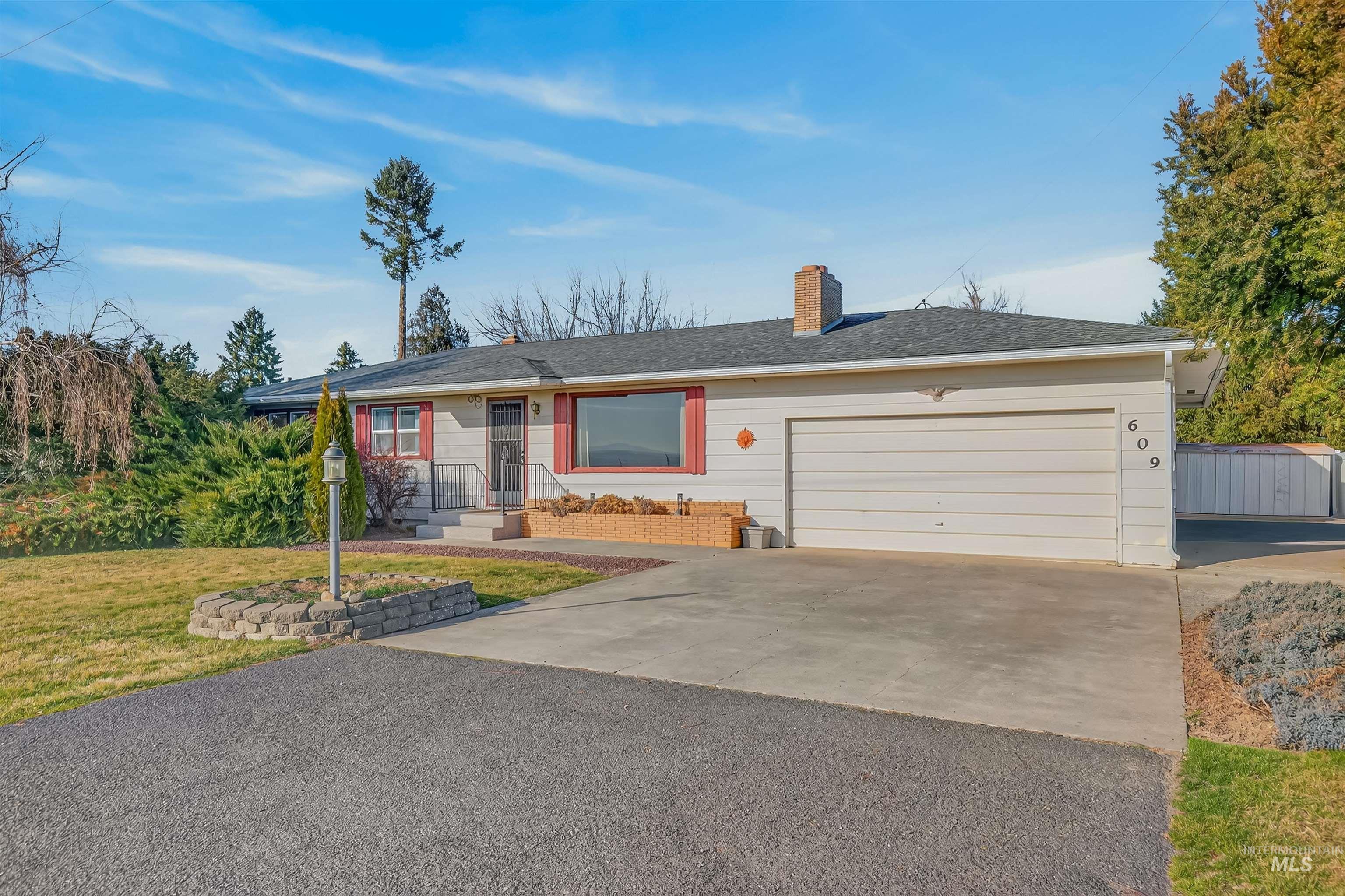 609 Grelle Avenue Lewiston, ID 83501 - Photo 5 of 48 Ranch-style home featuring asphalt driveway, a chimney, a front yard, an attached garage, and a shingled roof
