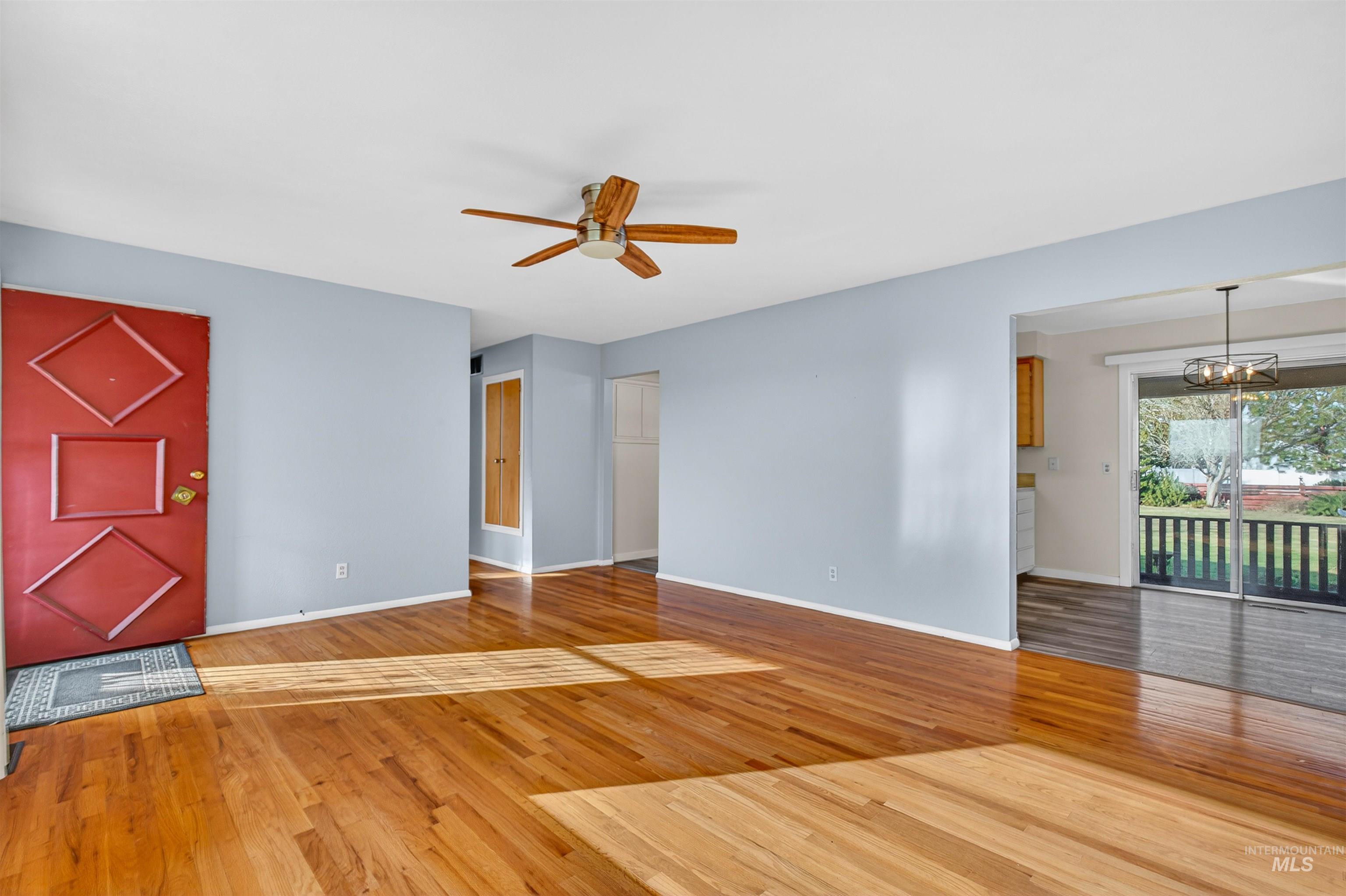 609 Grelle Avenue Lewiston, ID 83501 - Photo 8 of 48 Unfurnished living room with light wood-type flooring, ceiling fan, and hanging lights