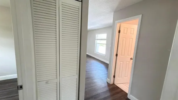 a view of a hallway with wooden floor