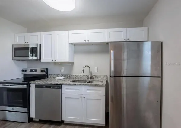 a white refrigerator freezer sitting in a kitchen