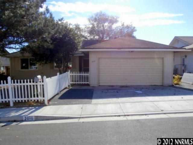 2010 Stardust Street Reno, NV 89503 - Photo 1 of 1 a view of a house with a small yard and wooden fence