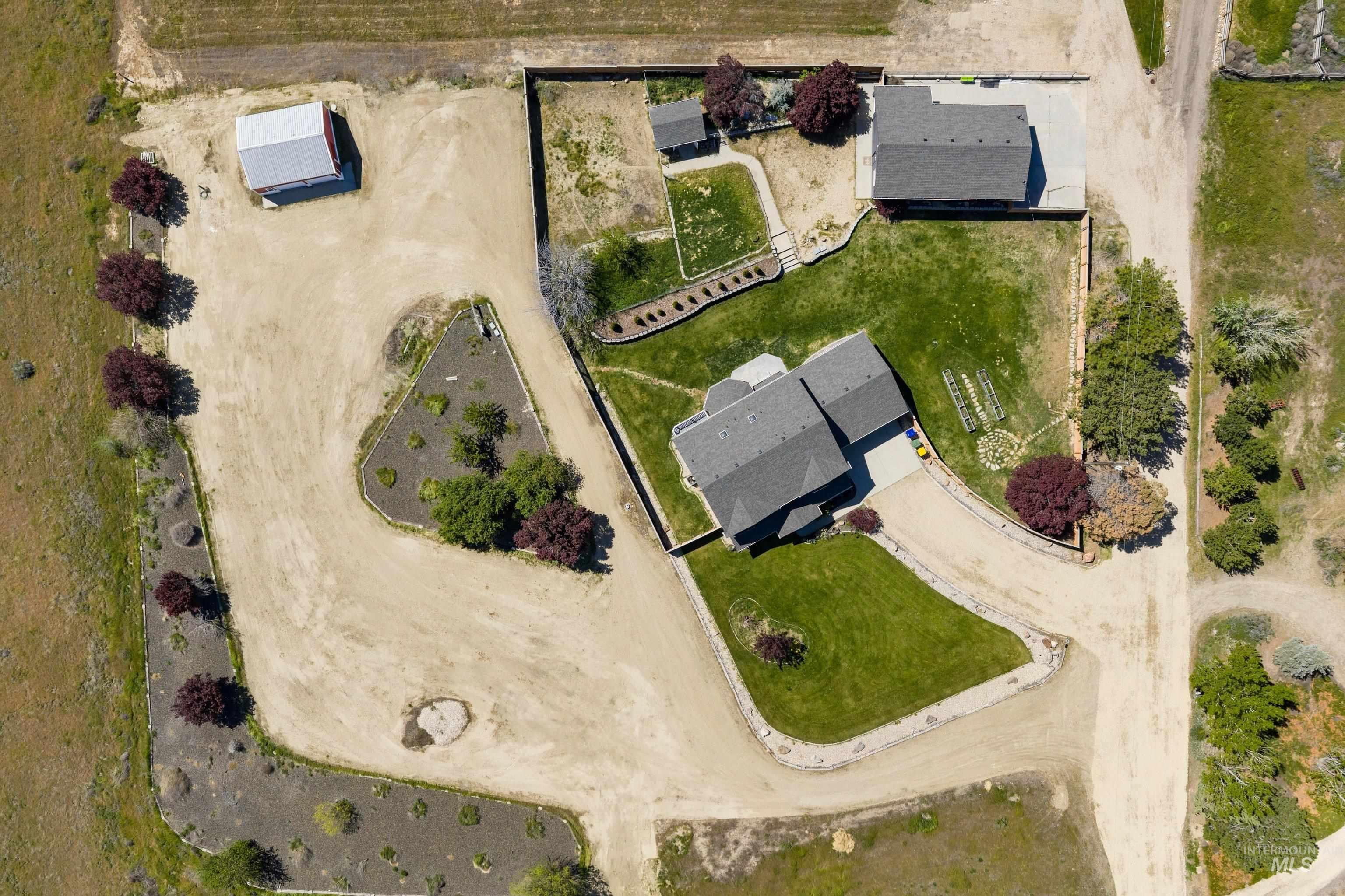 7657 Track Road Nampa, ID 83686 - Photo 43 of 49 Expansive property featuring two residential structures, a detached outbuilding, and mature landscaping
