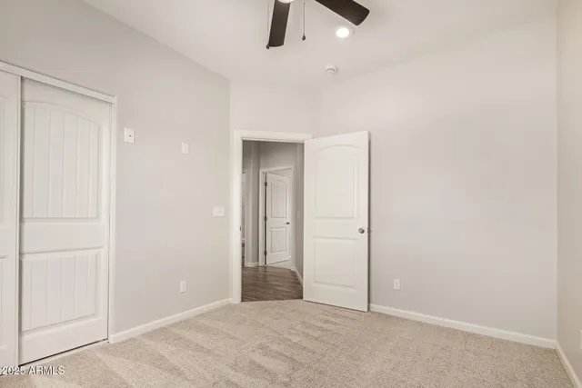 an empty room with a empty space and chandelier fan