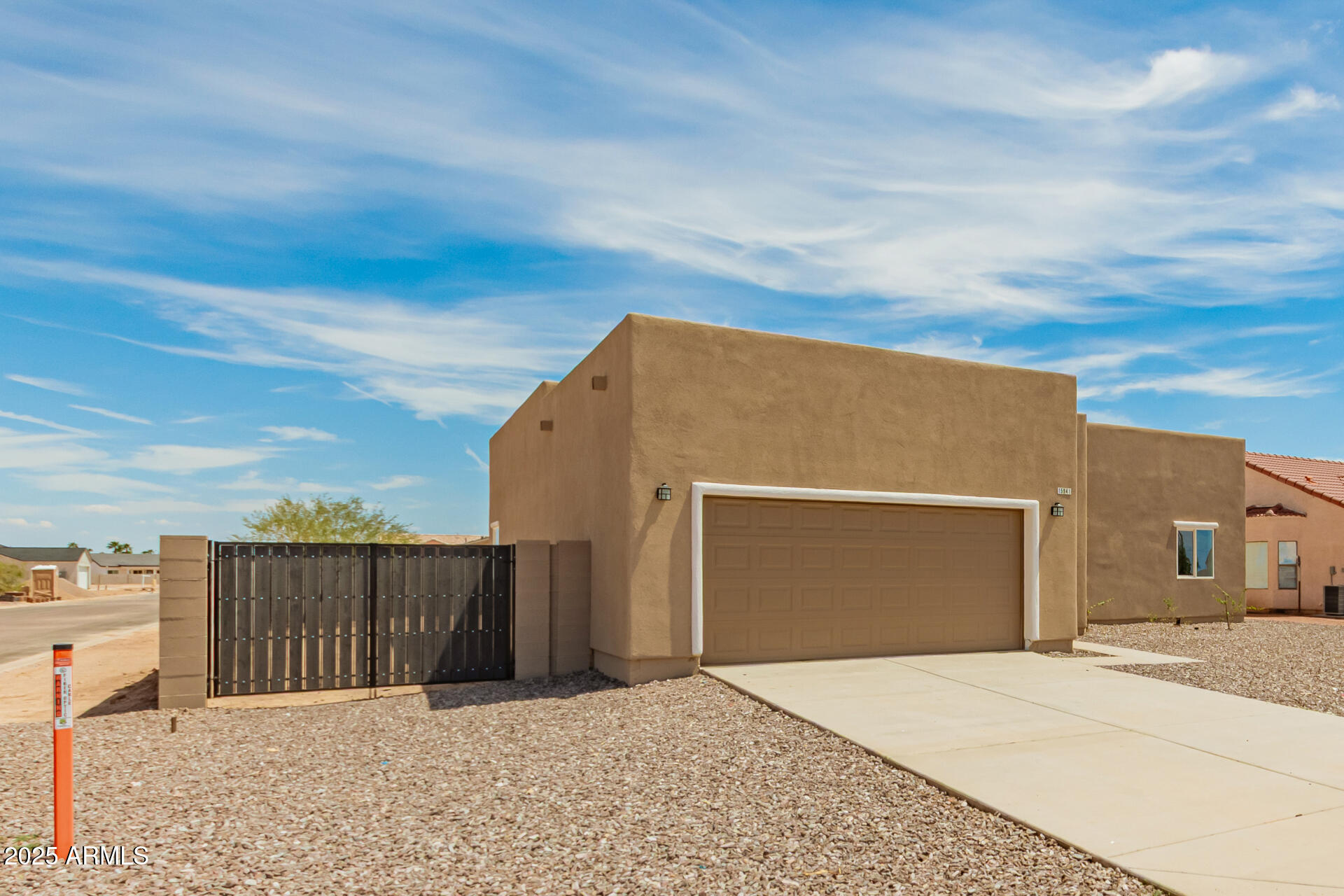 15941 South Animas Road Arizona City, AZ 85123 - Photo 2 of 26 a street view with wooden fence
