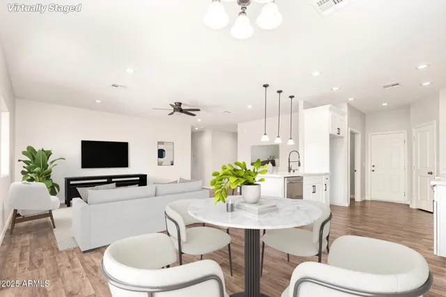 a living room with furniture a flat screen tv and a large mirror