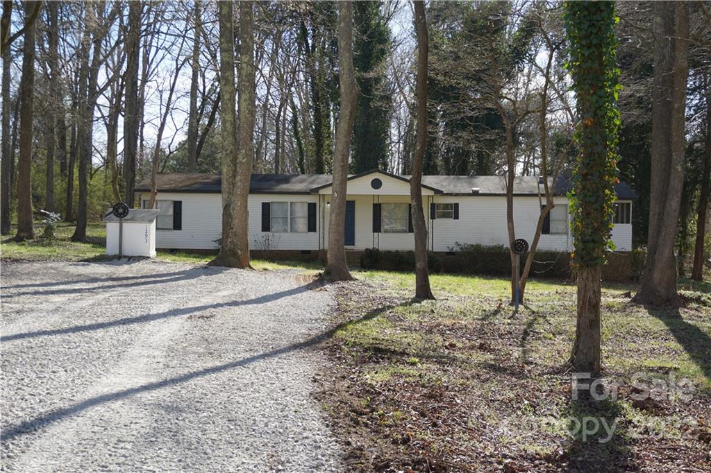 a house that has a tree in front of it