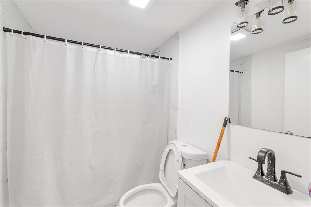 36 Brookledge Street Boston, MA 02121 - Photo 30 of 31 a bathroom with a sink and a mirror