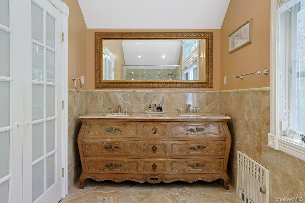 97 Underhill Road Scarsdale, NY 10583 - Photo 19 of 39 a bathroom with a sink and a mirror