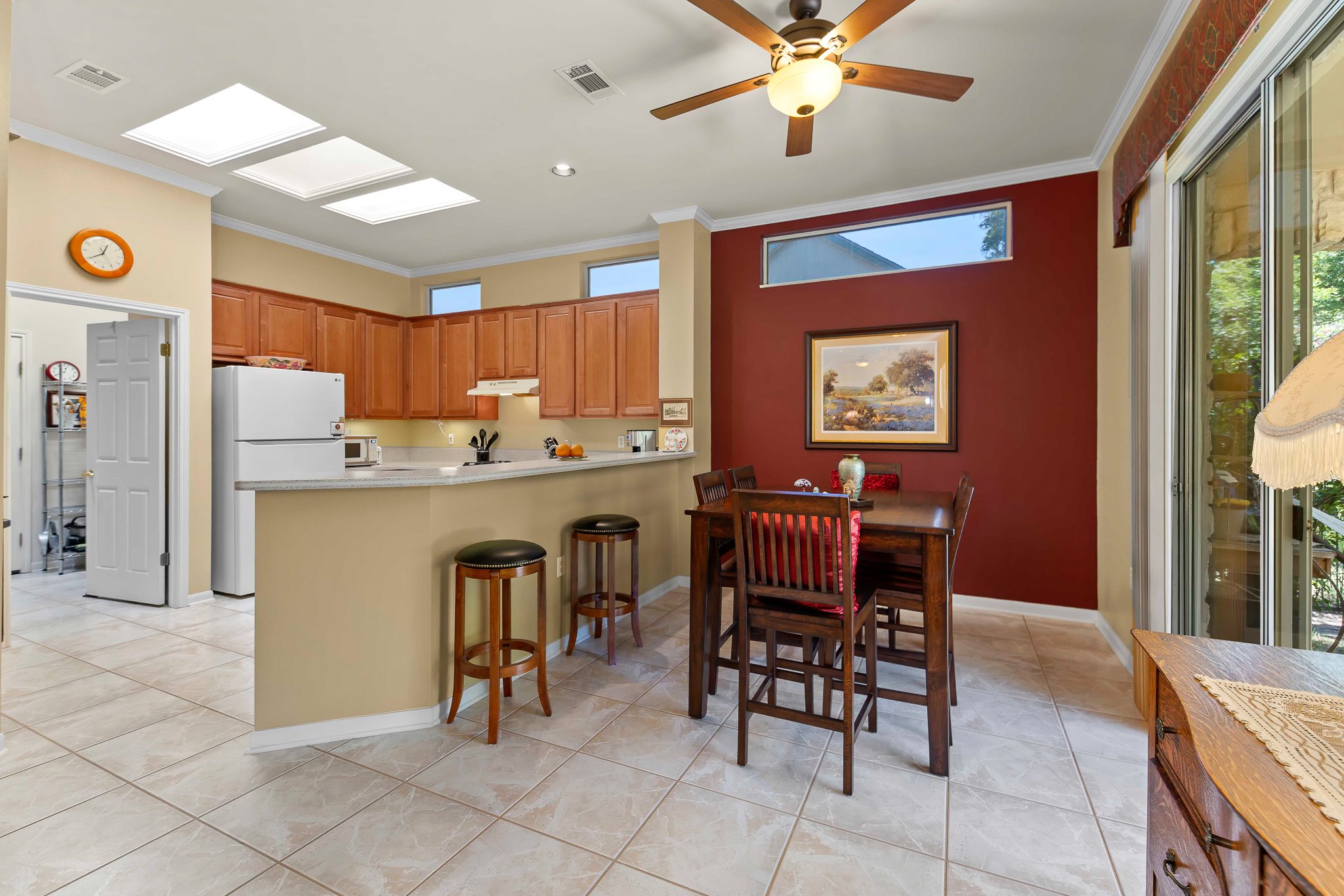 145 Stetson Trail Georgetown, TX 78633 - Photo 17 of 35 Breakfast room with high transom window, and sliders leading to the back porch. Skylight in the center of the kitchen, between the lightsKi