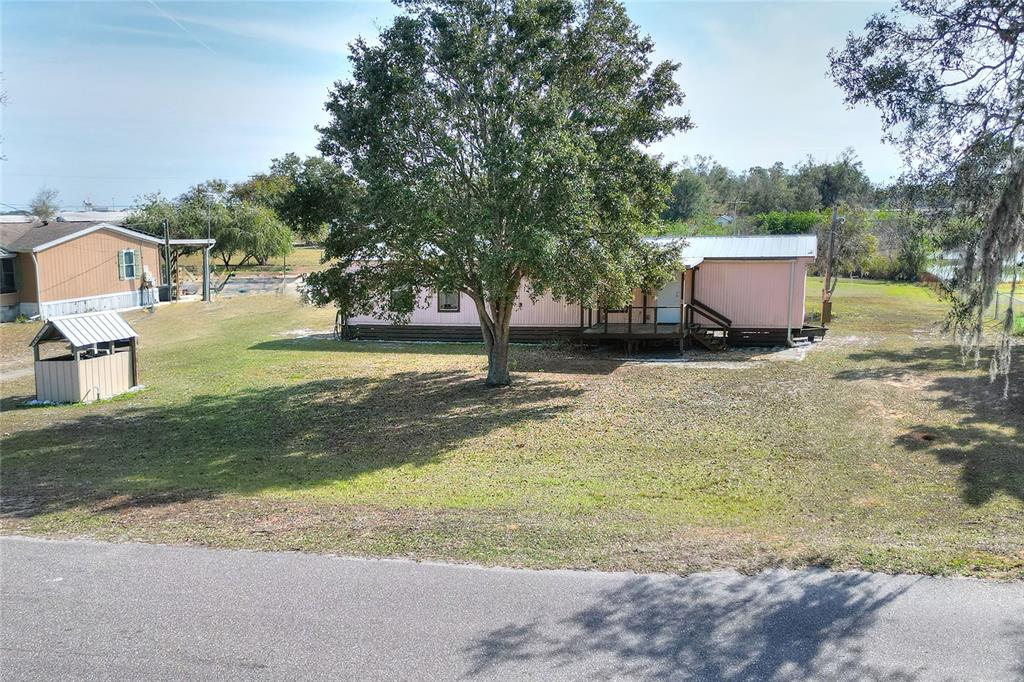3228 Spring Lake Road Lake Wales, FL 33898 - Photo 1 of 1 a backyard of a house with a yard and fountain