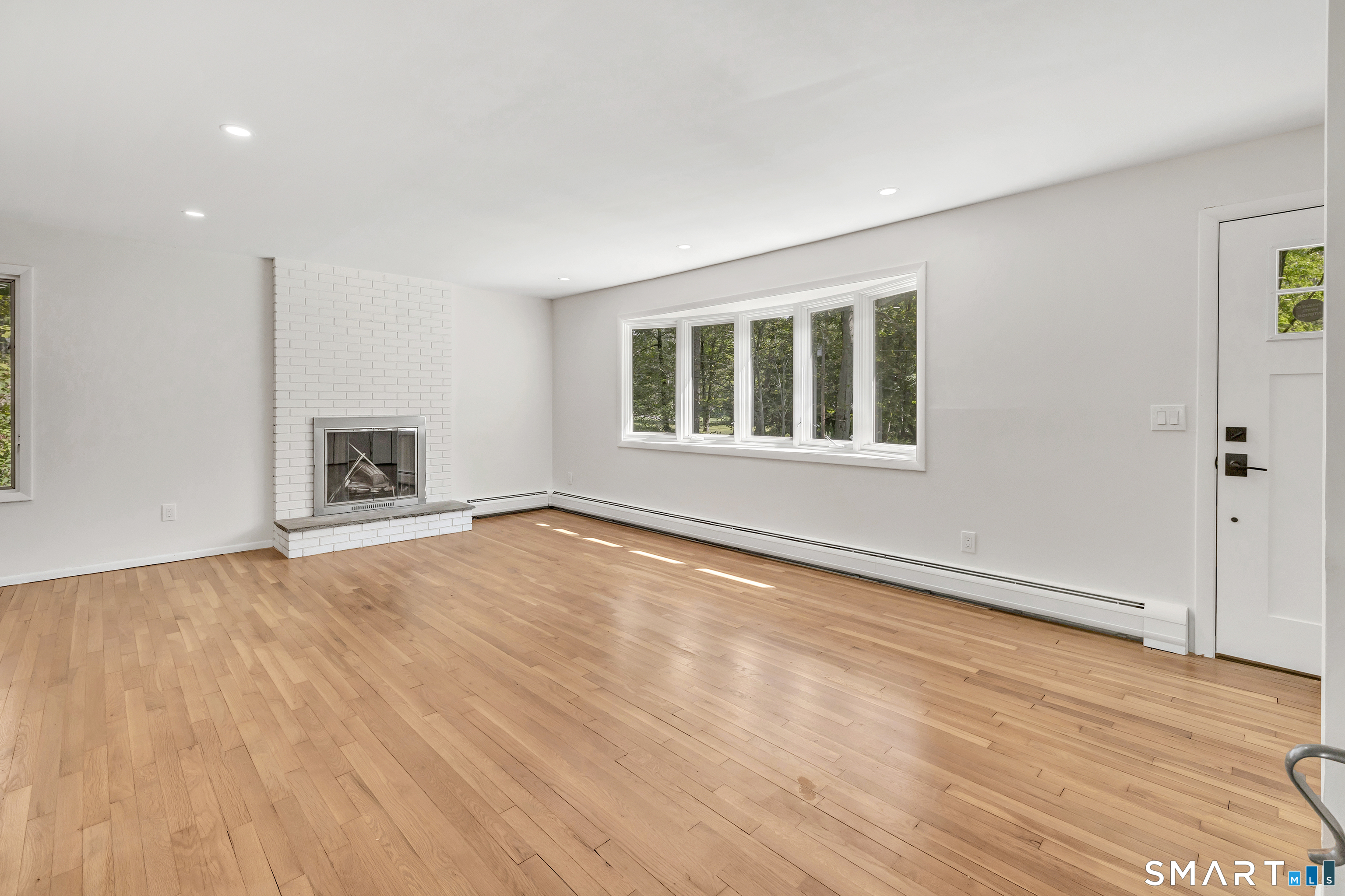 48 Crestwood Road Monroe, CT 06468 - Photo 15 of 32 a view of empty room with wooden floor and fireplace