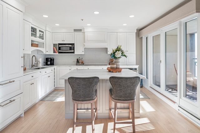 a view of kitchen island a sink and a refrigerator
