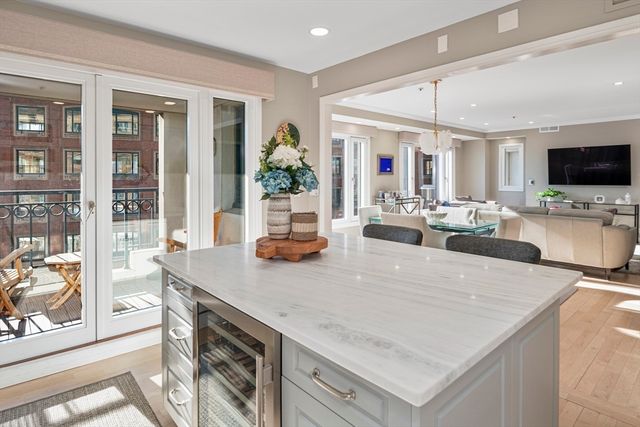 a kitchen with stainless steel appliances granite countertop a kitchen island a stove a table and chairs in it