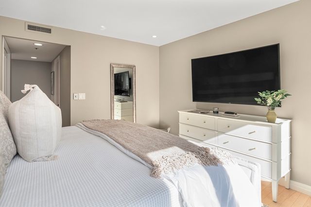 a bathroom with a granite countertop shower sink and mirror