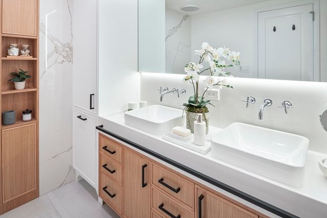 a bedroom with a bed couch and a large window