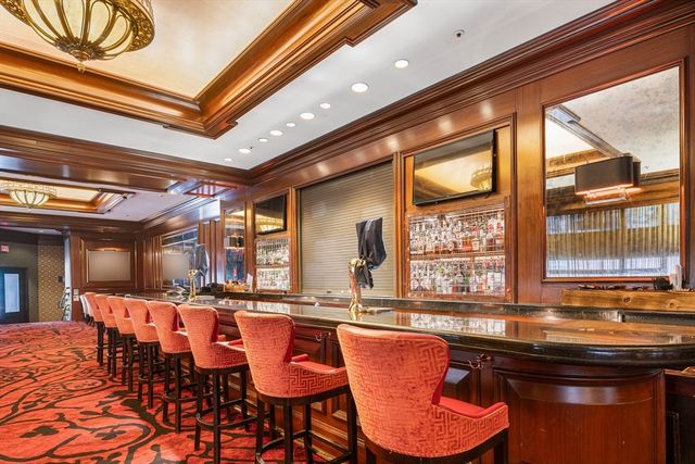 a view of a swimming pool and outdoor seating