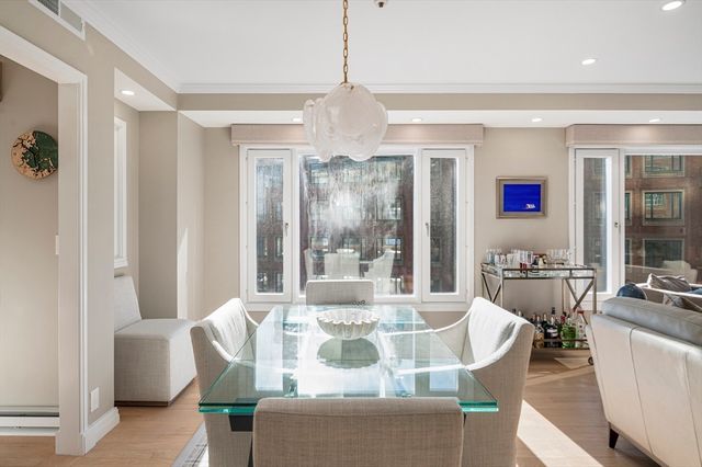 a view of a dining room with furniture large window and wooden floor