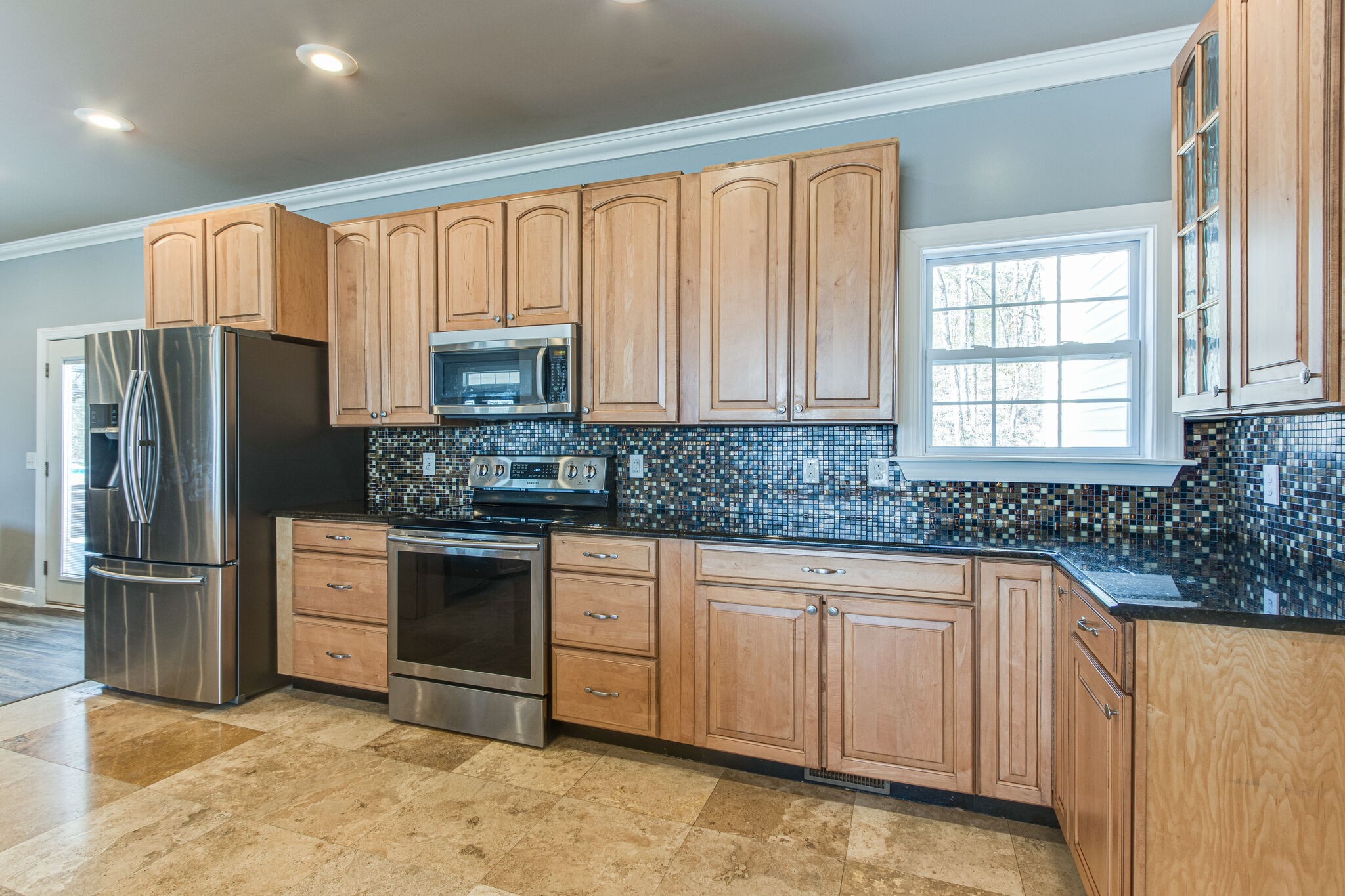 14100 Newtown Road Unionville, TN 37180 - Photo 14 of 41 a kitchen with granite countertop a refrigerator sink and cabinets