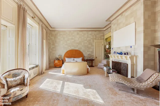 a bedroom with a bed and a large window