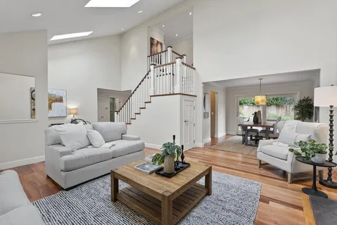 a living room with furniture a rug and a chandelier
