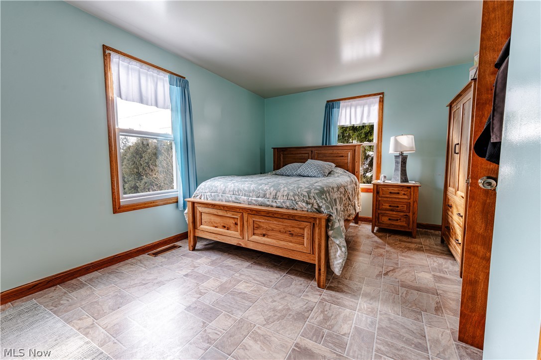 16350 Nauvoo Road Middlefield, OH 44062 - Photo 16 of 50 Bedroom with stone finish floors and baseboards