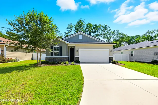 a front view of house with yard and green space