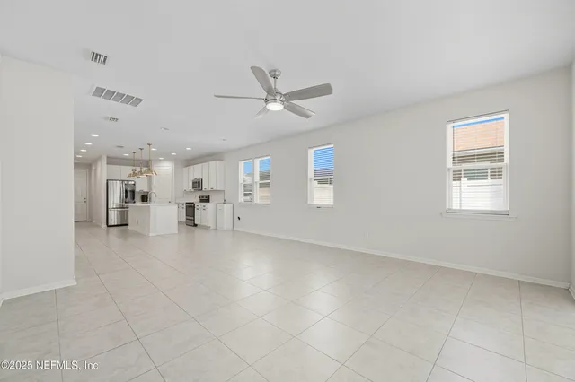 a view of a livingroom with furniture and a ceiling fan