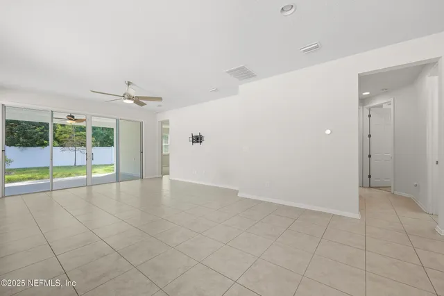 an empty room with sliding glass door