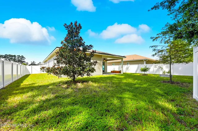 a view of a house with a backyard