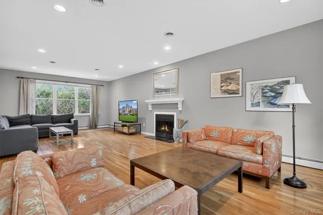 a living room with furniture a large window and a fireplace