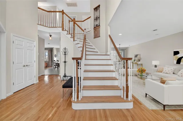 a view of entryway and hall with wooden floor