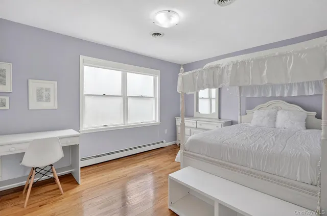 a bedroom with a bed and a chair